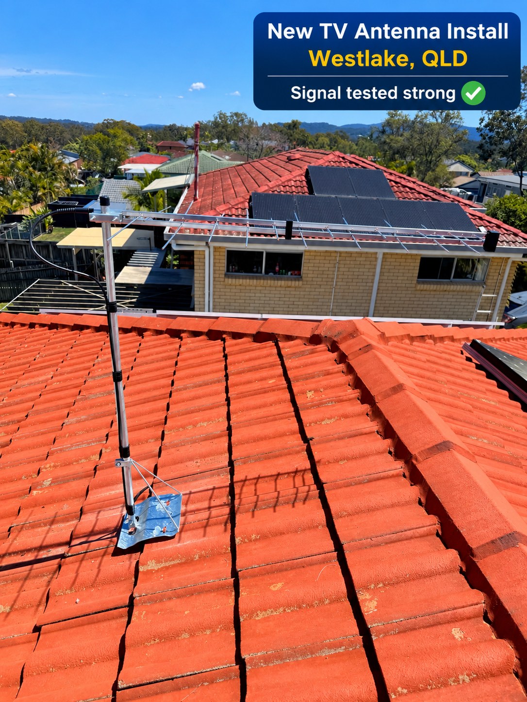 Completed TV antenna and braced mast mounted on a red tiled rooftop at Westlake